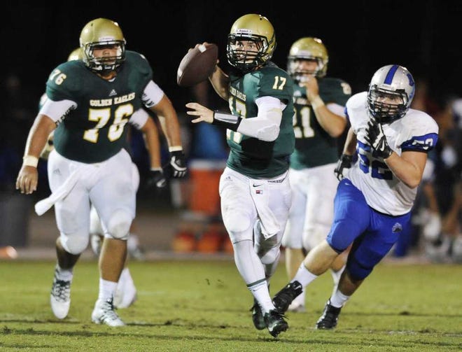 Bob.Self@Jacksonville.com Fleming Island quarterback Mike Scarnecchia (17) looks for a receiver as he scrambles during the second quarter against Bartram Trail on Friday.