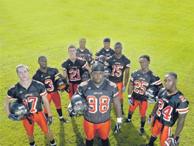 John Brown, center, of Lakeland High School is surrounded by teammates at the school. From left are Paul Wilson, Chris Rainey, Steve Wilks, Michael Pouncey, Maurkice Pouncey, Jordan Hammond, Jamar Taylor and Ahmad Black. Seven of the Dreadnaught players went on to play for the University of Florida Gators.