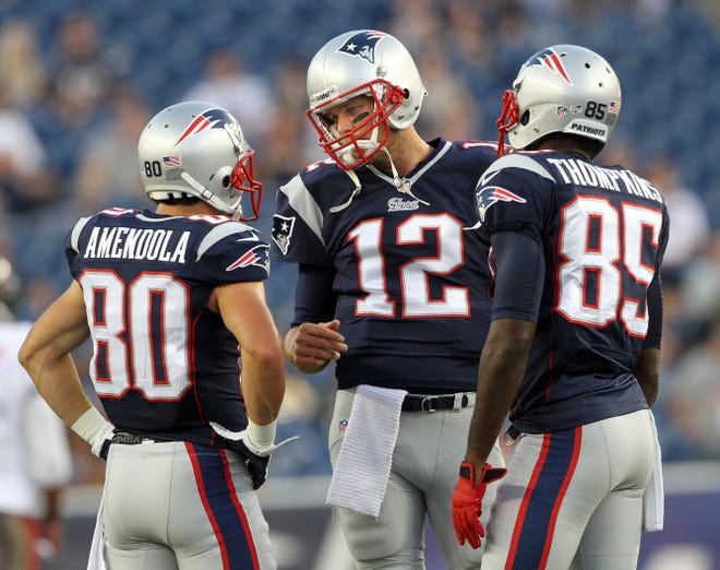 Patriots QB Tom Brady, center, will have to develop a rapport with a new corps of receivers, including Danny Amendola, left, and Kenbrell Thompkins, as the Pats begin their season today against the Bills in Buffalo.