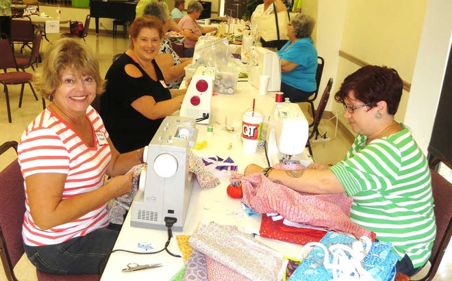 Church volunteers cut fabric and sewed 200 dresses for young girls in Honduras and Guatamala on Aug. 24 during the Great Day of Service.