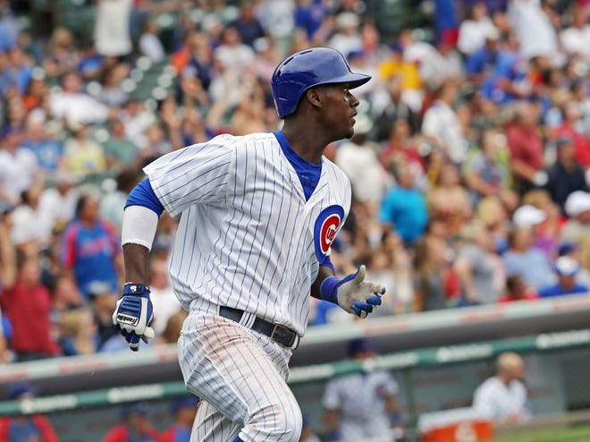 Chicago Cubs' Junior Lake watches his solo home run in the fifth inning during a baseball game against the Milwaukee Brewers, Sunday, Sept. 8, 2013 in Chicago. (AP Photo/Charles Cherney)
