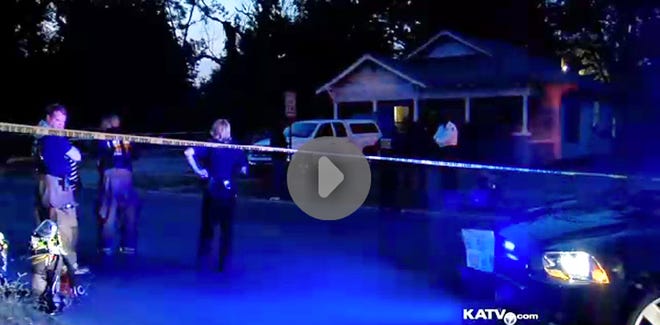 In an image made from video provided by KATV, police surround a home in Pine Bluff, Ark., Saturday, Sept. 7, 2013 during a standoff that left an elderly man dead. Lt. David Price told KATV that when officers arrived at the home they learned that an aggravated assault had occurred against two people. Arkansas SWAT officers shot and killed the suspect, Monroe Isadore, who authorities say is 107-year-old old, when he pointed a weapon at them. (AP Photo/courtesy of KATV)