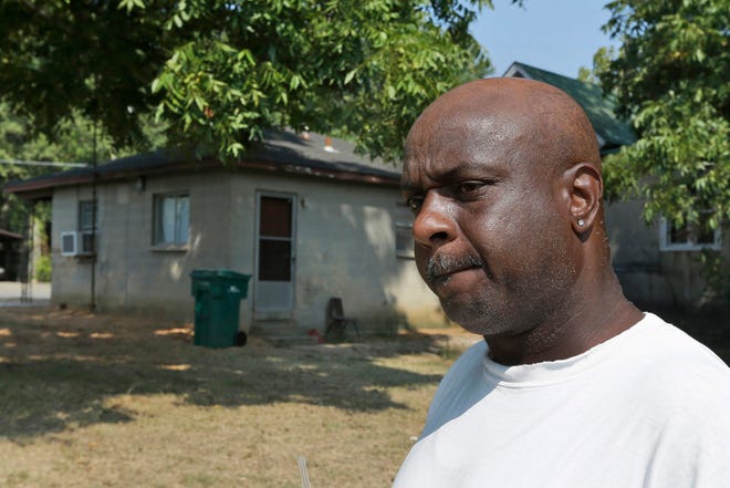 Dwayne Grant, former neighbor of 107-year-old Monroe Isadore, is interviewed Monday, Sept. 9, 2013, near Isadore's former residence in Pine Bluff, Ark. Police halted a standoff at another address Saturday, Sept. 7, when they shot Isadore who they say opened fire at them. (AP Photo/Danny Johnston)
