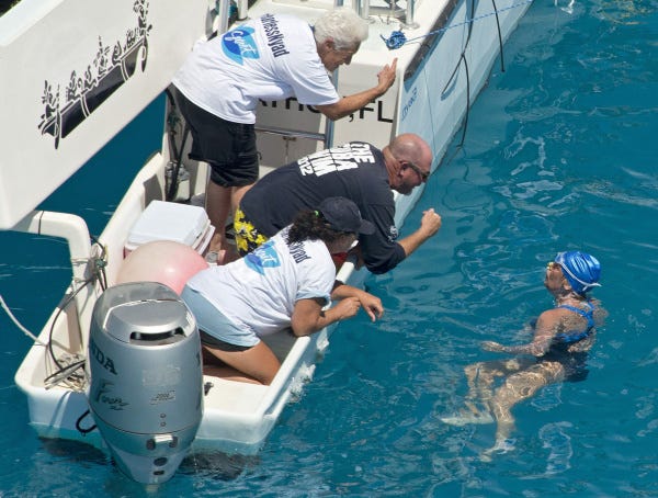Long-distance swimmer Diana Nyad talks with her crew off Key West, Fla. Some people in the endurance-swimming community have questions about her Cuba-to-Florida swim last week.