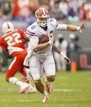 Will Vragovic Tampa Bay Times  Florida quarterback Jeff Driskel runs with the ball in the second half against Miami at Sun Life Stadium on Saturday. He threw for 291 yards in the loss.