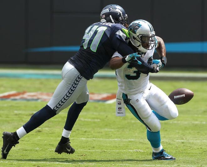 Panthers running back DeAngelo Williams loses the ball when hit by Seattle's Byron Maxwell during their game Sunday at Bank of America Stadium.