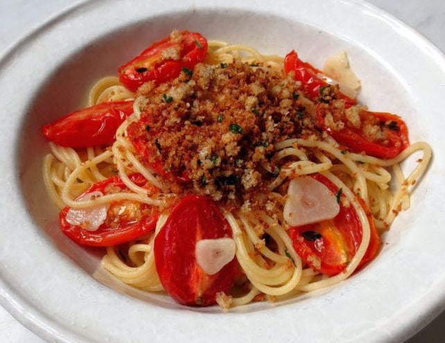 Roasted tomatoes bring an intense sweetness to this simple spaghetti dish. A salty mixture of breadcrumbs and anchovies provides flavor contrast and crunch.