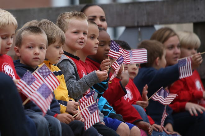Students from the Zeeland Christian Preschool waved to a cheering crowd Monday morning during the 2013 Zeeland Memorial Day Parade.