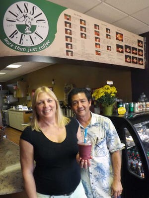 Juliann Earl and Doug Thomas, owners of Classic Bean, have opened a drive-thru location on S.W. 29th. Earl, pictured holding one of the business' many slushees, said the location will focus on inexpensive snack-type foods, smoothies and espressos.