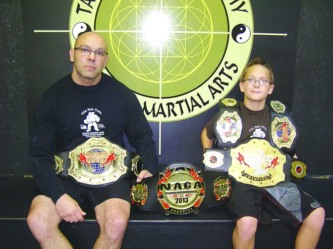 Josh Hummer and son Jevik could pass as superheroes with the belts they have earned in mixed martial arts competitions. They both placed first in the same national event this summer.