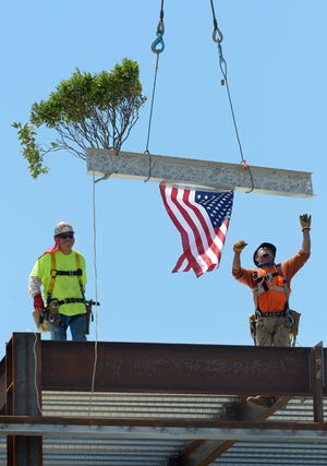 In this Times-News file photo, workers place the main beam at Alamance Regional's new Cancer Center.