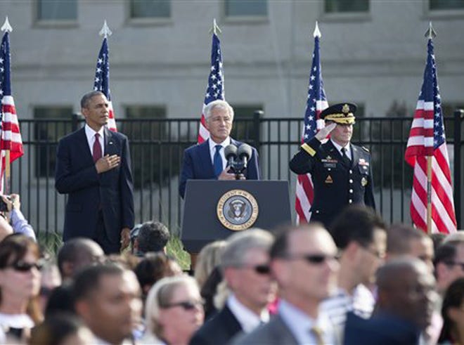From left, President Barack Obama, Defense Secretary Chuck Hagel and Joint Chiefs Chairman Gen. Martin Dempsey, pay their respects to the victims of the Sept 11 attacks during a remembrance ceremony at the Pentagon, Wednesday, Sept. 11, 2013.