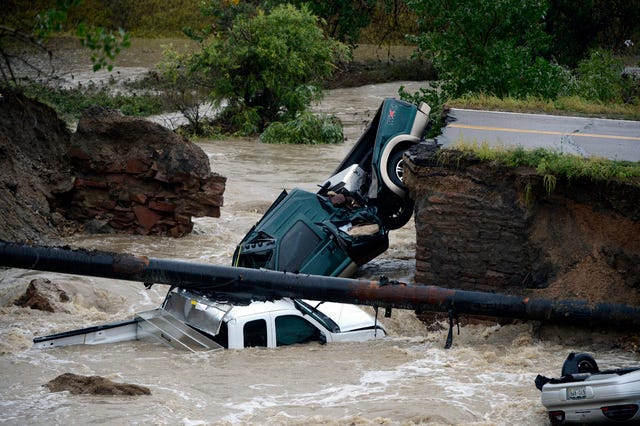 ADDS MORE PRECISE LOCATION INFORMATION- Three vehicles sit in water after crashing where a road collapsed following flooding at Highway 287 and Dillon at the Broomfield/Lafayette border, Colo., on Thursday, Sept. 12, 2013. Three people were rescued. The National Weather Service has warned of an "extremely dangerous and life-threatening situation" throughout the region. (AP Photo/The Denver Post, Andy Cross)