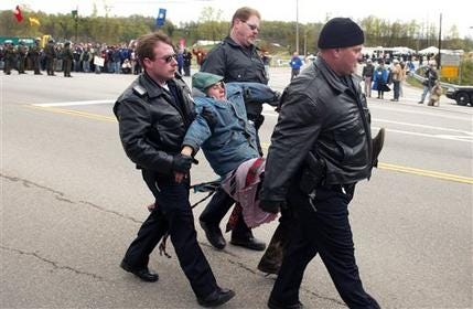 This March 30, 2003 file photo shows members of the Oak Ridge Police department carrying a protestor during her arrest in front of the Y-12 nuclear weapons plant in Oak Ridge, Tenn.