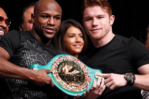 Boxers Floyd Mayweather, left, and Canelo Alvarez pose during a press conference in Las Vegas, Wednesday, Sept. 11, 2013. The pair are scheduled to fight on Saturday for Mayweather's WBA Super World and Alvarez's WBC junior middleweight titles.