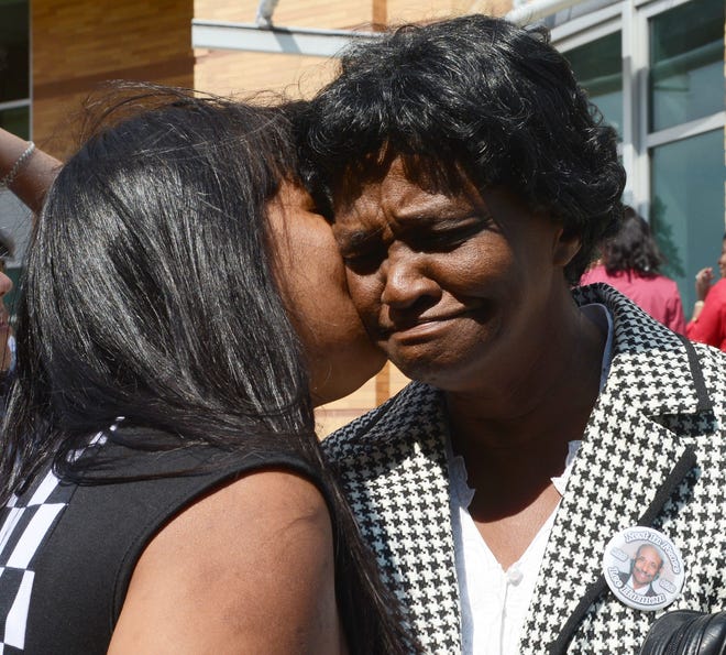 Francis Harmon, right, wife of the late Lee Harmon, is comforted outside the courthouse. Carlos Ramon Velazquez, 35, of Brockton has been charged with murder on Thursday, Sept. 12, 2013 for the beating death of 74-year old Lee Harmon.