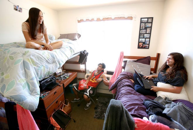 Shelby Ryan, 18, left, from Sherman Oaks, a freshman at Cal State Northridge, and her roommate Abby Souza, 18, right, from Davis, hang out inside their dorm room with Austin Garcia, 18, from Bakersfield, who was visiting from his room located down the hall of the coed dorm, August 26. All three students are freshmen.