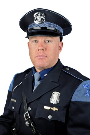 In this Aug. 8, 2011 photo released by the Michigan State Police, Trooper Paul Butterfield of the Hart post is shown. Butterfield was fatally shot in Mason County on Monday, Sept. 9, 2013. Butterfield stopped a vehicle at 6:20 p.m. in Sherman Township and three minutes later a motorist called 911 to report that a trooper had been shot in the head. Butterfield died during emergency surgery at Munson Medical Center. (AP Photo/Michigan State Police)
