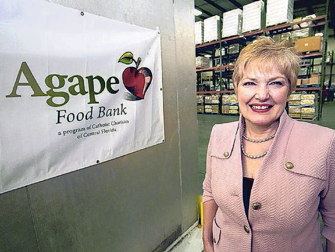 Kim Long, Director of Agape Food Bank, stands inside the organizations's warehouse in Lakeland Wednesday. September 11, 2013.
