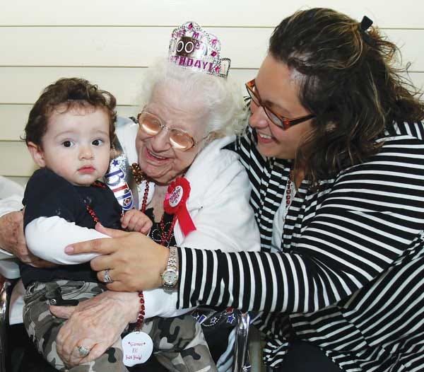 Photo by Tracy Klimek/New Jersey Herald - Garnet Osborne’s great-grandson, Nate, sits on her lap next to his mother, Mellisa Wilcox, as they celebrate Osborne’s 100th birthday.