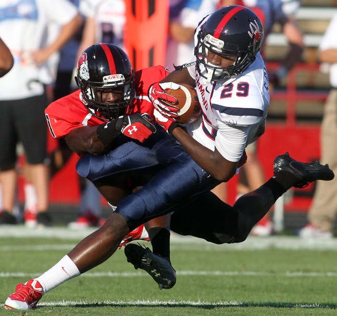 GWU defender Ivan Toomer battles to bring down Richmond wideout Stephen Barnette (29) -- who had 12 catches on the day for the Spiders -- in Saturday's contest at Spangler Stadium. The Runnin' Bulldogs knocked off the nation's 11th-ranked team, 12-10.