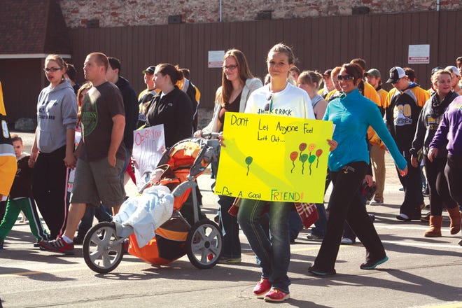 Hundreds of Eastern Upper Peninsula residents took to the streets of Sault Ste. Marie on Saturday, taking part in the first ever “Walk and Rock Against Bullying” event. Here, walkers — consisting of community members, students, athletes, and families — travel north on Ashmun after stopping traffic downtown. This walker’s sign reads “Don’t let anyone feel left out...Be a good friend.”