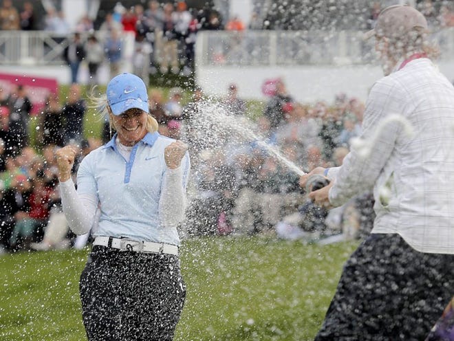 Suzann Pettersen of Norway is sprayed with champagne by a friend after winning the Evian Championship women's golf tournament in Evian, eastern France, Sunday, Sept. 15, 2013. (AP Photo/Laurent Cipriani)