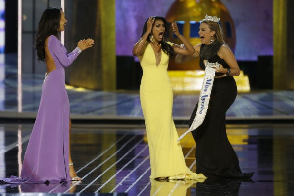Miss New York Nina Davuluri, center, reacts after being named Miss America 2014 as Miss California Crystal Lee, left, and Miss America 2013 Mallory Hagan celebrate with her in Atlantic City, N.J. Davuluri, 24, became the first contestant of Indian heritage and the second consecutive contestant from New York to win last night. She performed a Bollywood fusion dance for her talent presentation.