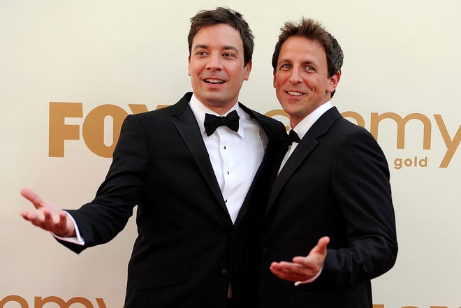 This Sept. 18, 2011, photo shows Jimmy Fallon, left, and Seth Meyers at the 63rd Primetime Emmy Awards in Los Angeles. Meyers is moving from his "Weekend Update" desk to his own late night show on NBC. The network said Sunday, May 12, 2013, that the longtime "Saturday Night Live" cast member will replace Jimmy Fallon at the 12:35 a.m. "Late Night" show. Fallon will be moving up an hour as Jay Leno's replacement on the "Tonight" show. 

(AP Photo/Chris Pizzello, file)