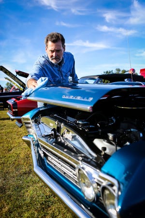 Jack Frost of Ashburnham polishes his 1967 Pontiac Chevelle during the Milford Lions Club's 26th annual charity Car Show at Plains Park in Milford on Sunday.