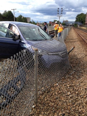Train service through the South Shore slowed down Monday afternoon after a Zipcar ended up on the train tracks off Newport Avenue in North Quincy. The driver was cited in the crash.