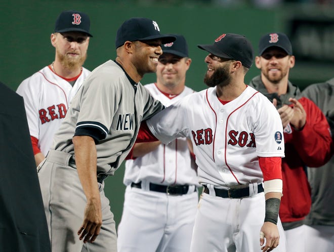New York Yankees relief pitcher Mariano Rivera, left, embraces Boston Red Sox's Dustin Pedroia during a tribute to Rivera before the start of a baseball game at Fenway Park, in Boston, Sunday, Sept. 15, 2013.