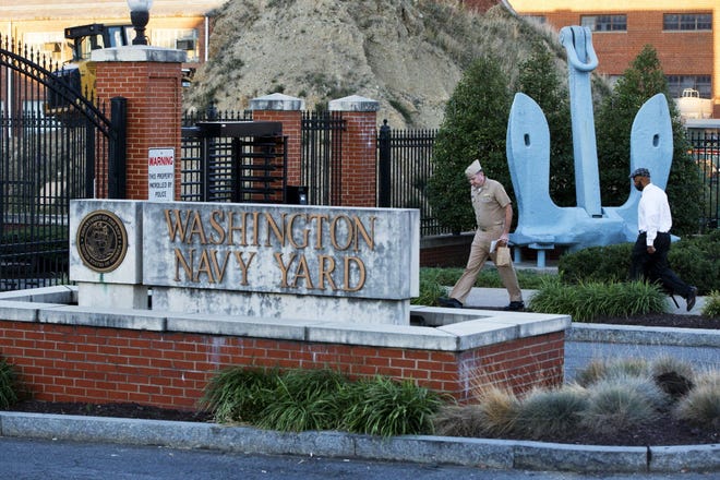 Essential personnel are allowed into the closed Washington Navy Yard in Washington, on Tuesday, Sept. 17, 2013, the day after a gunman launched an attack.
