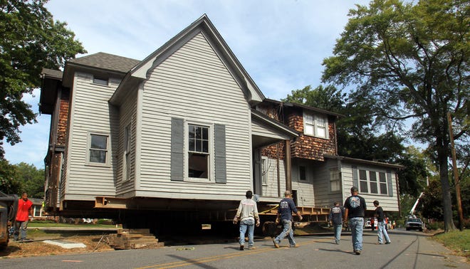 House movers from Simmons House Moving Inc. work to relocate the 230-ton historic house to the corner of North Morgan Street and Wells Street on Monday. (Brittany Randolph/The Star)
