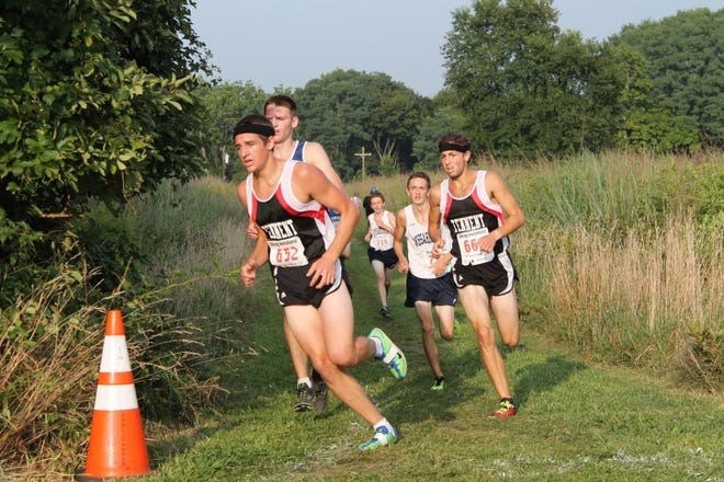 William Tennent's Jesse Coleman (left) leads teammate Eli Segal around a corner during the season-opening John Sharp Viking Invitational. The Panthers won the boys' race.