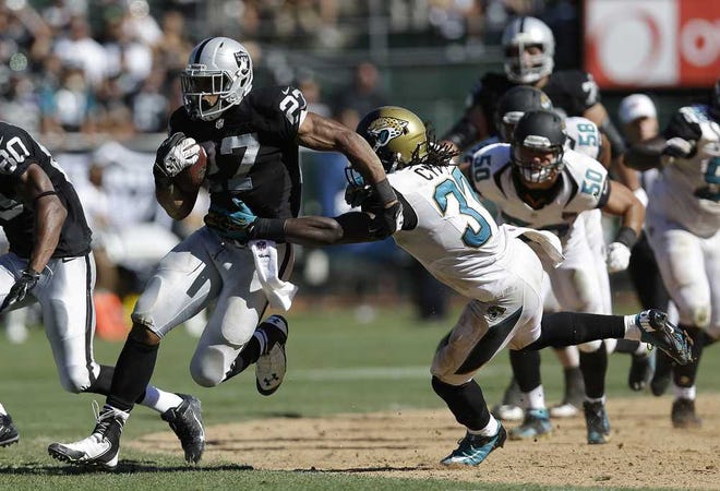 Marcio Jose Sanchez Associated Press Jaguars free safety John Cyprien (center) attempts to tackle Raiders running back and former Jaguars player Rashad Jennings during the fourth quarter of Sunday's game in Oakland, Calif.