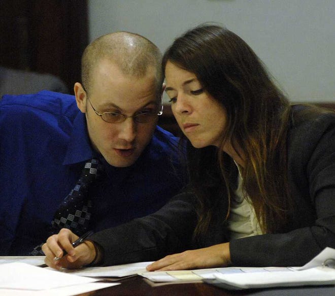 Terry.Dickson@jacksonville.com Guy Heinze Jr. confers with April Herbert, one of his defense lawyers, during juror qualifying for his upcoming murder trial in the beating deaths of eight people in 2009.