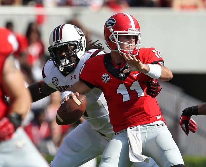 Jason Getz Associated Press Georgia quarterback Aaron Murray attempts a pass under pressure from South Carolina defensive end Jadeveon Clowney on Sept. 7. Murray threw four touchdown passes in the game. His next TD pass will be his 100th at UGa.
