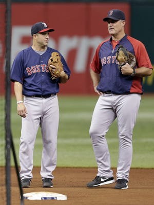 Red Sox manager John Farrell, right, talks to veteran shortstop and PC alum John McDonald before a game last week against the Tampa Bay Rays.