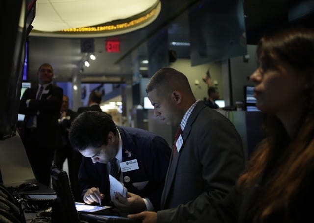 FILE - In this Tuesday, Sept. 3, 2013, file photo, traders work on the floor at the New York Stock Exchange in New York. An Associated Press poll released Tuesday, Sept. 17, 2013 of more than two dozen economists suggests that global growth will remain below full health into 2014. (AP Photo/Seth Wenig, File)