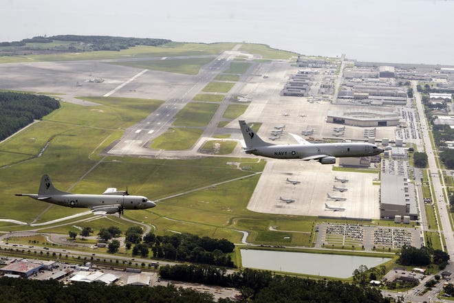A P-3C Orion, left, and the new P-8A Poseidon, both attached to the VP-30 "Pro's Nest," fly in formation over NAS Jacksonville. The Poseidon is replacing the Orion as the preeminent land-based aircraft in the Navy's Maritime Patrol and Reconnaissance Force.