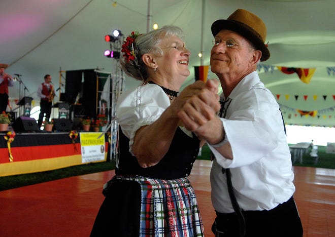 Shirley and Larry Hackmann, of Washington, enjoy a song together as they dance at Peoria's Oktoberfest on Saturday afternoon. The event, organized by the German American Central Society and the Peoria Park District, began on Friday and lasts through Sunday.