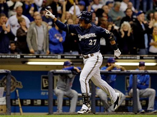 Milwaukee Brewers' Carlos Gomez reacts after hitting a two-run home run during the seventh inning of a baseball game against the Chicago Cubs, Tuesday, Sept. 17, 2013, in Milwaukee.