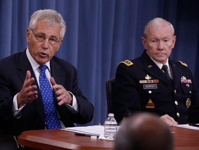 Defense Secretary Chuck Hagel and Chairman of the Joint Chiefs of Staff Gen. Martin Dempsey discuss reviewing security measures at U.S. military installations worldwide following the Washington Navy Yard shootings at a news conference at The Pentagon on Wednesday.
(CHARLES DHARAPAK | THE ASSOCIATED PRESS)