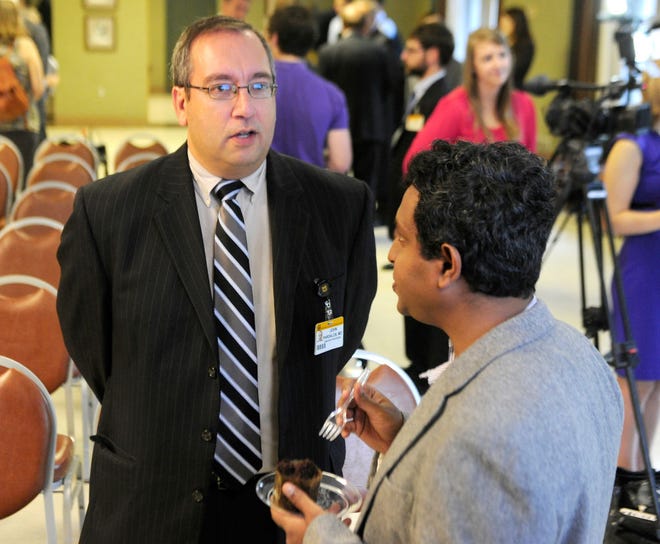 John Pardalos, left, associate professor of clinical child health at the MU School of Medicine, and Shramik Sengupta, associate professor in the Department of Bioengineering, talk Wednesday at Memorial Union after their project received a grant from the Coulter Translational Partnership Program.