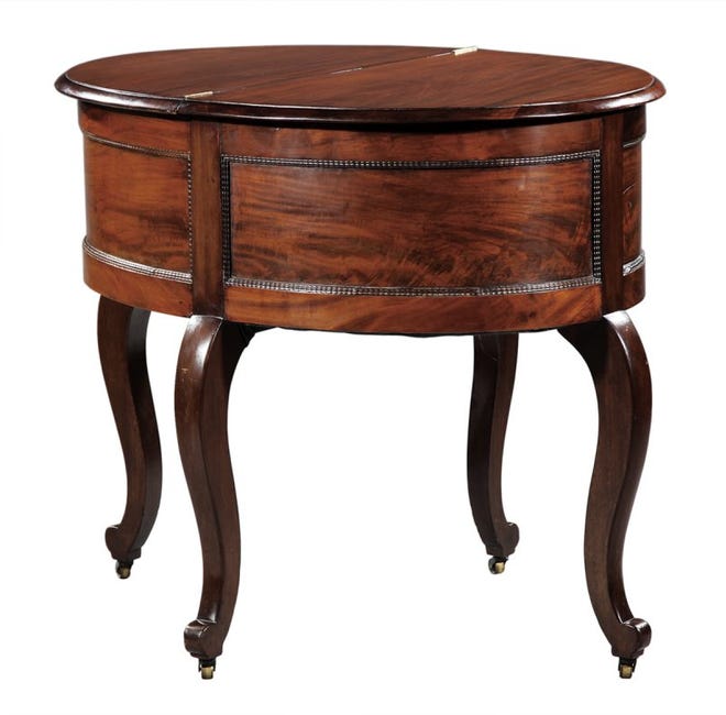 This piece of furniture can turn into a table or remain a rounded desk and chair. It sold for $4,481 at a Neal Auction Co. sale last November. It was made by a New York City furniture craftsman in about 1854.