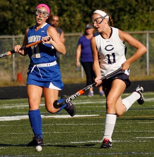 #11 Norwell Elaina Cipriano and #11 Cohasset Valerie Farren try to run down the ball on Wednesday Sept. 18, 2013.