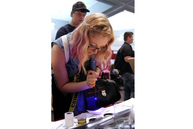 Rachel Rodemann • Times Record / Whitney Colclasure, freshman criminal justice major at the University of Arkansas at Fort Smith, does an experiment with crime scene investigation tools at the criminal justice booth of the UAFS majors expo, Wednesday, Sept. 18, 2013. 
 Rachel Rodemann • Times Record / Emily Green, professional adviser with the University of Arkansas at Fort Smith, hands out "passports" to students entering the UAFS majors expo, Wednesday, Sept. 18, 2013, to mark off visited booths. 
 Rachel Rodemann • Times Record / Susan Simkowski, professor at the University of Arkansas at Fort Smith, hands out Jell-O from the Media Communication booth of the UAFS majors expo, which featured an "Animal House" theme, Wednesday, Sept. 18, 2013. 
 Rachel Rodemann • Times Record / Michael Dugan, right, and Jason Keyes, welding professors at the University of Arkansas at Fort Smith, explain the dynamics of a welding major at the UAFS majors expo, Wednesday, Sept. 18, 2013.