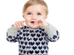 This product image released by J. Crew shows a gray cashmere sweater with blue hearts from J. Crew's new baby collection, which launched Sept. 18.