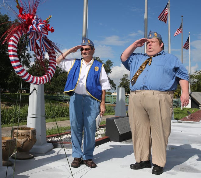 Squadron Adjutant Bruce Rogers (left) and squadron Commander Brett Kinney, of the Sons of the American Legion, salute at a POW-MIA recognition ceremony Thursday at Veterans Park on La. 311 in Houma. Today is National POW-MIA Recognition Day.